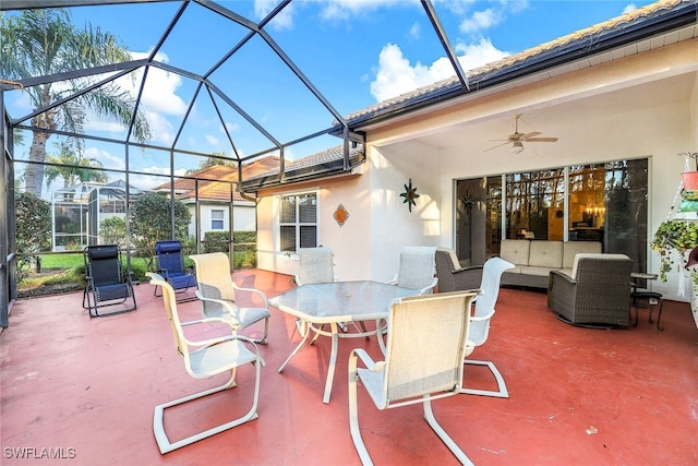 view of patio featuring outdoor lounge area, ceiling fan, and a lanai