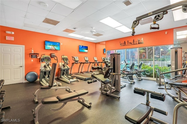 gym with a drop ceiling and ceiling fan