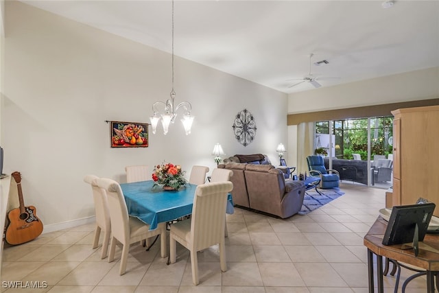 tiled dining area featuring ceiling fan with notable chandelier