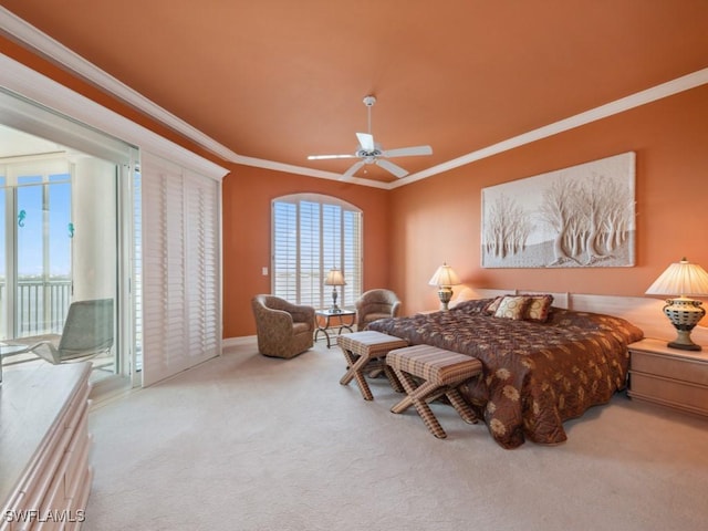 carpeted bedroom with access to exterior, ceiling fan, and ornamental molding