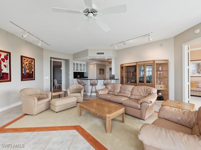 tiled living room featuring ceiling fan and track lighting