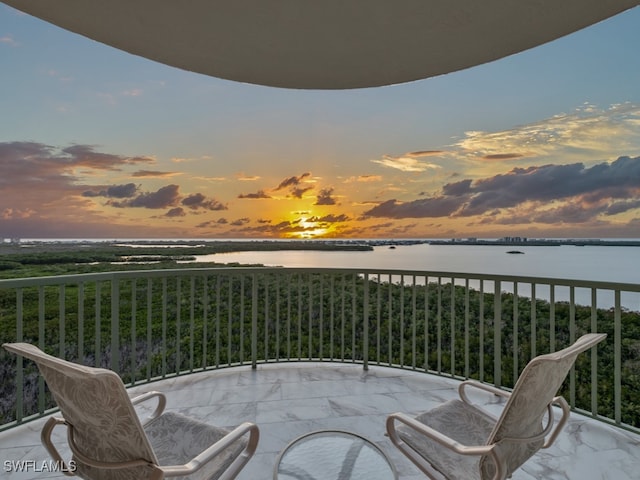 balcony at dusk with a water view