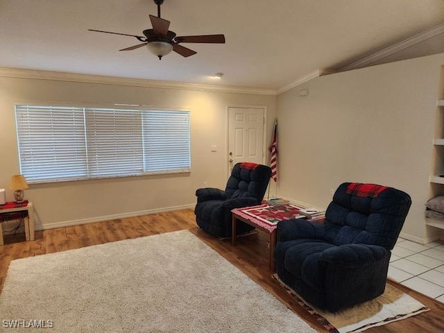 living area featuring hardwood / wood-style flooring, crown molding, and ceiling fan