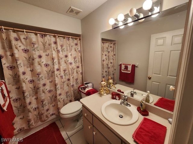 bathroom with tile patterned flooring, a shower with shower curtain, vanity, a textured ceiling, and toilet