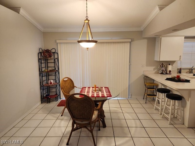 tiled dining space with sink and ornamental molding