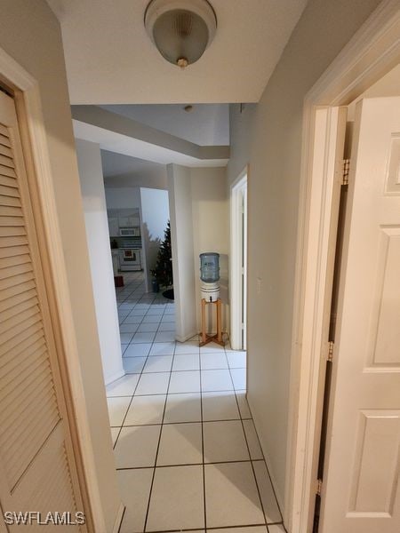 hall featuring light tile patterned floors