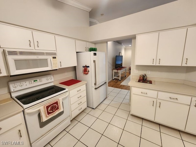 kitchen with crown molding, white appliances, light tile patterned floors, and white cabinets