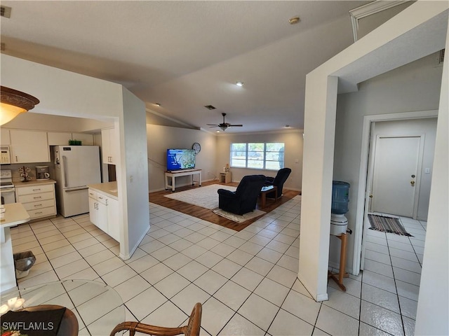 tiled living room with vaulted ceiling and ceiling fan