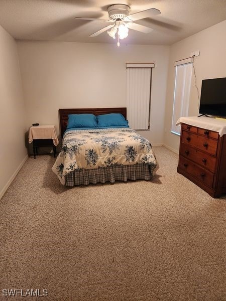 bedroom with baseboards, a ceiling fan, and light colored carpet