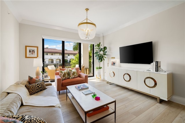 living room featuring light wood-type flooring, crown molding, and a chandelier