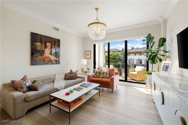 living room with ornamental molding, light wood-type flooring, and a notable chandelier