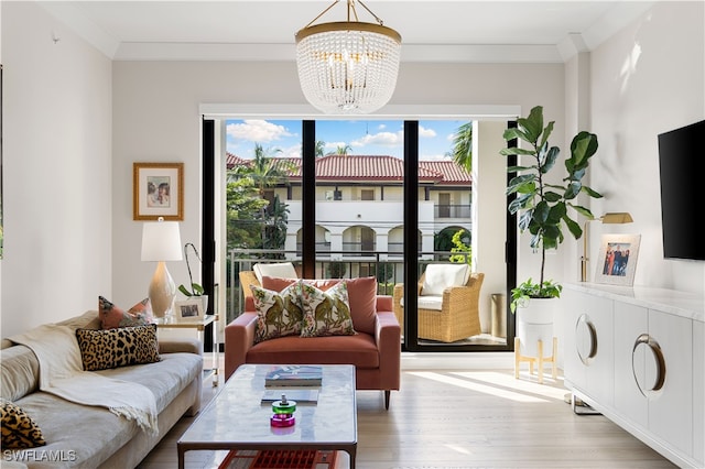 living room with ornamental molding, hardwood / wood-style flooring, and a notable chandelier