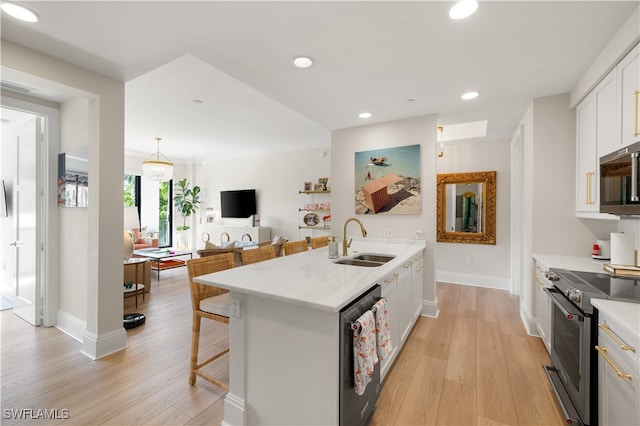 kitchen featuring white cabinets, stainless steel appliances, light hardwood / wood-style flooring, and sink