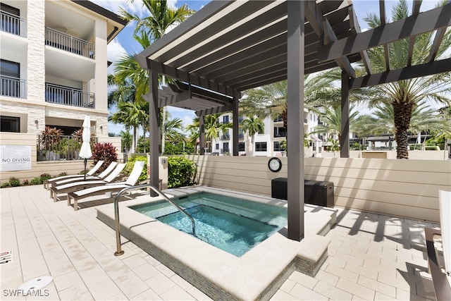 view of pool with a community hot tub and a pergola