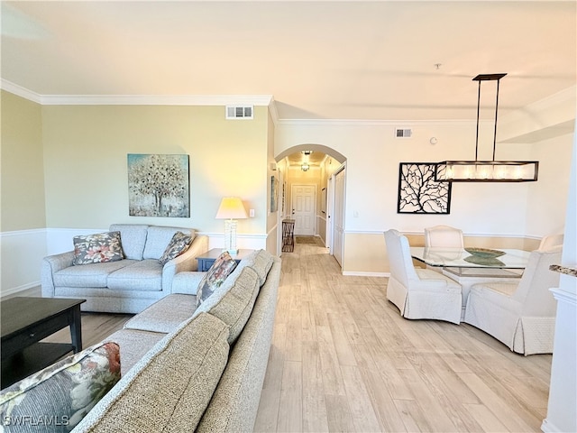 living room with light hardwood / wood-style flooring and ornamental molding