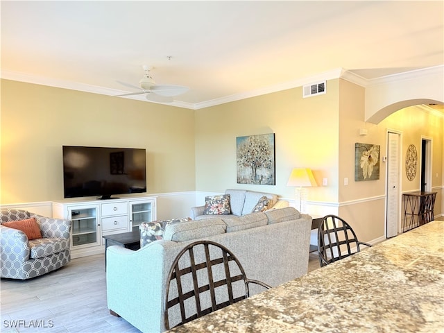 living room featuring ceiling fan, light hardwood / wood-style flooring, and ornamental molding