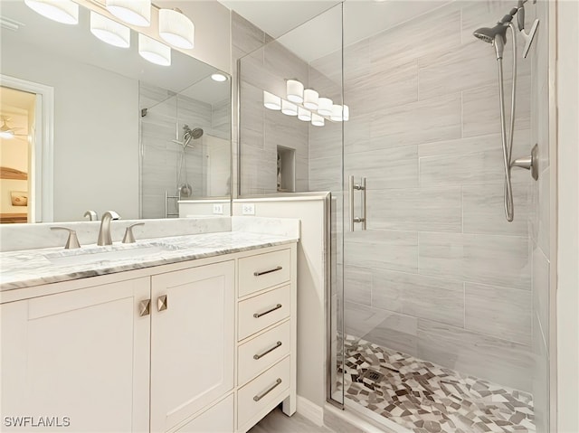 bathroom with vanity and a shower with shower door