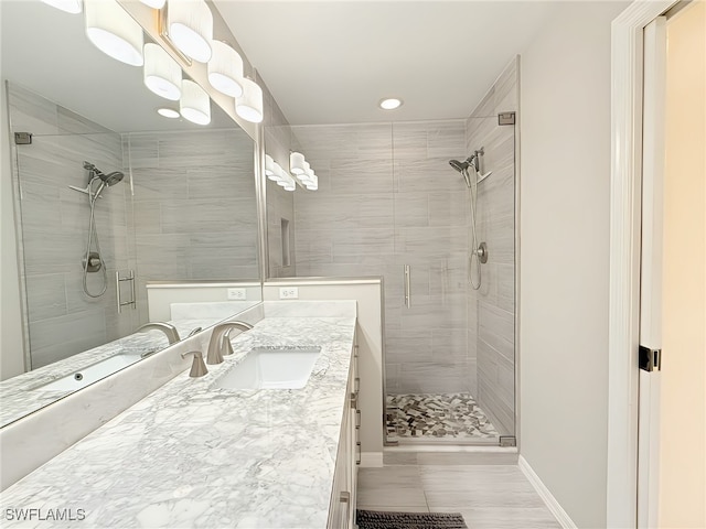 bathroom featuring vanity and a shower with shower door