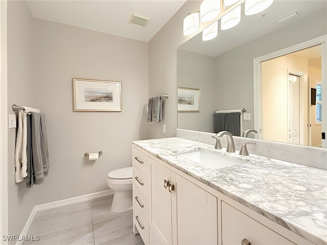 bathroom with vanity and toilet