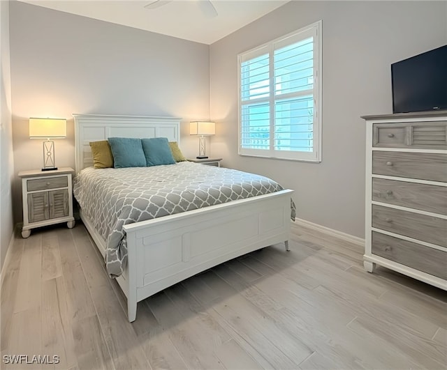 bedroom with light hardwood / wood-style flooring and ceiling fan