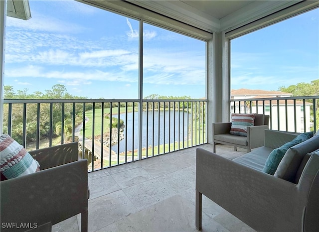 sunroom / solarium with a water view and plenty of natural light