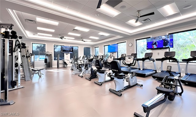 workout area featuring a paneled ceiling, ceiling fan, and ornamental molding