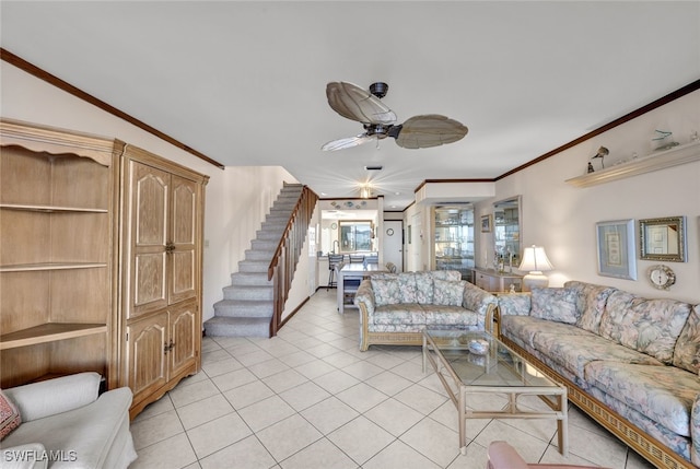 living room with light tile patterned floors, ceiling fan, and ornamental molding