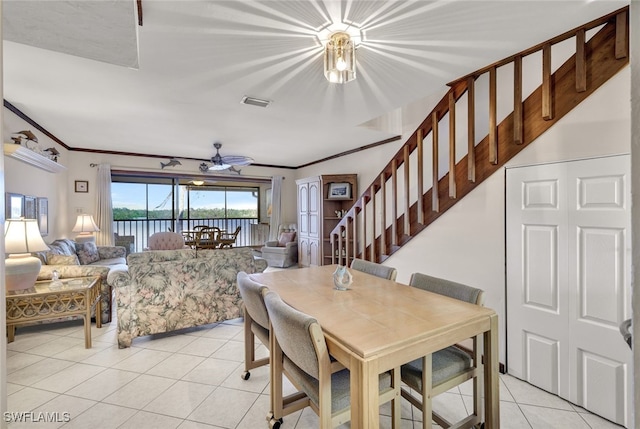 dining room featuring light tile patterned floors, ceiling fan, and crown molding