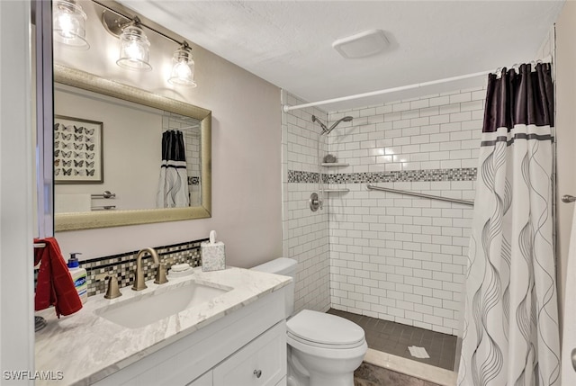 bathroom with a shower with curtain, vanity, and toilet