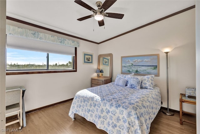 bedroom with ceiling fan, light wood-type flooring, and crown molding