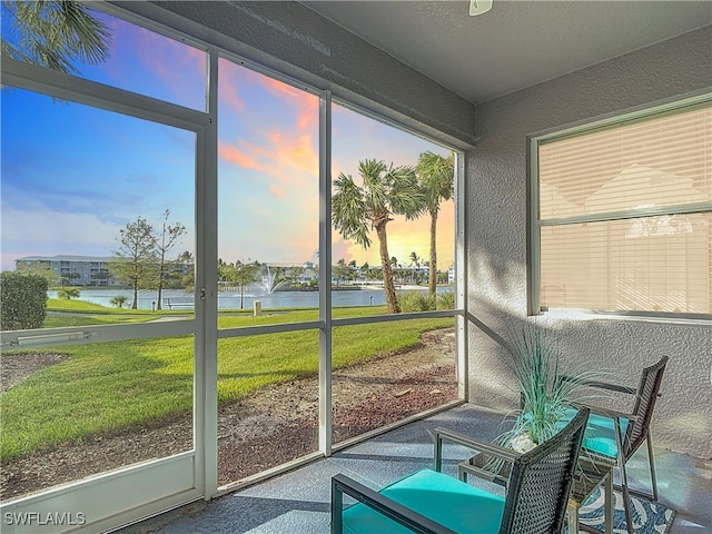 sunroom / solarium with plenty of natural light and a water view