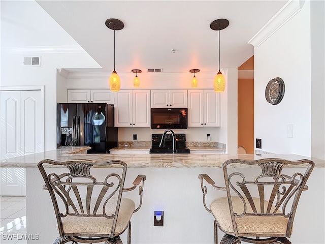 kitchen with white cabinets, decorative light fixtures, kitchen peninsula, and black appliances