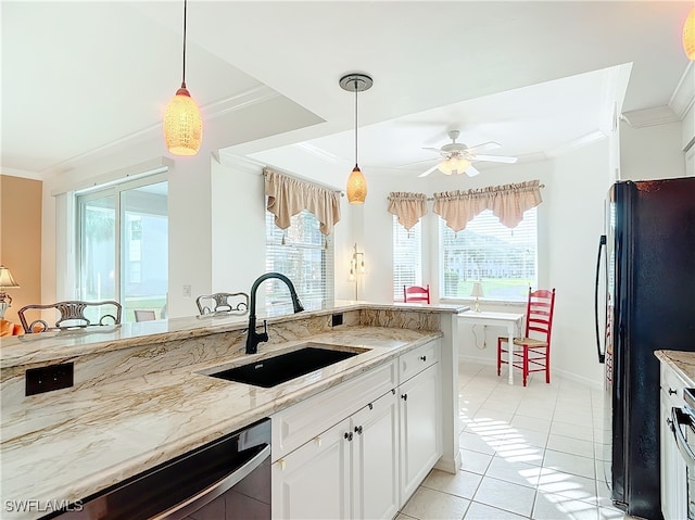 kitchen featuring black fridge, ornamental molding, sink, pendant lighting, and white cabinetry