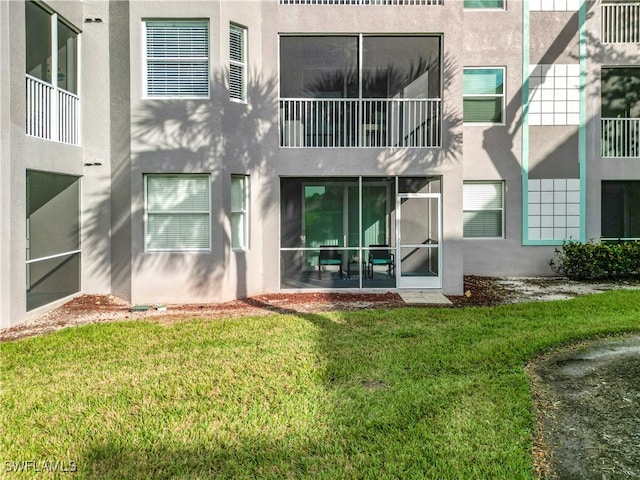 rear view of property featuring a yard