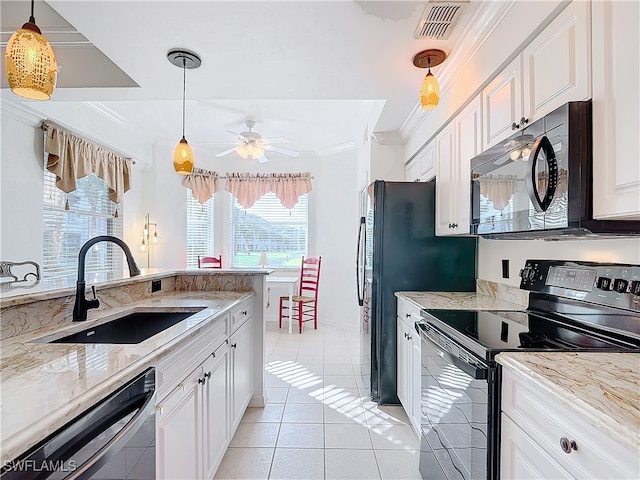 kitchen with black appliances, white cabinets, sink, and a wealth of natural light