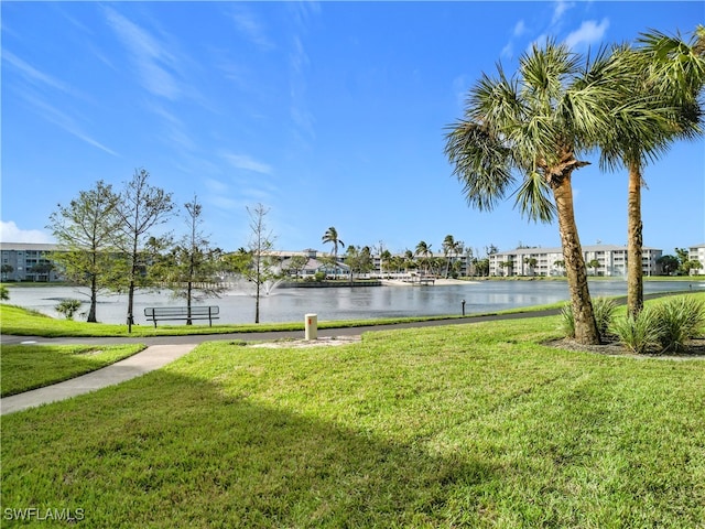 view of property's community with a water view and a yard