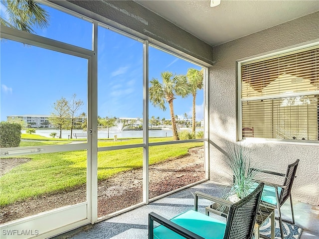 unfurnished sunroom featuring a water view