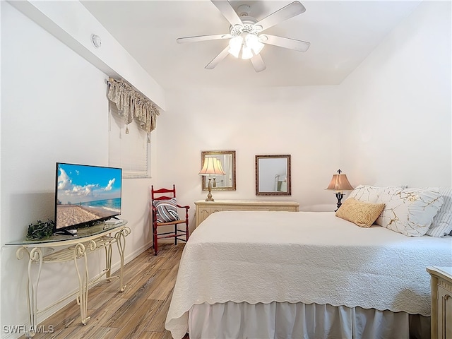 bedroom with ceiling fan and hardwood / wood-style floors