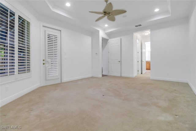 interior space with visible vents, a raised ceiling, and recessed lighting