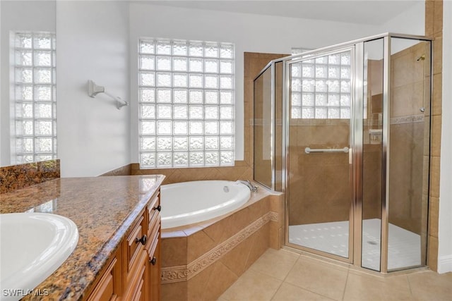 full bathroom with tile patterned floors and plenty of natural light