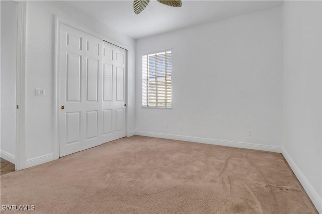 unfurnished bedroom featuring a closet, baseboards, and carpet floors