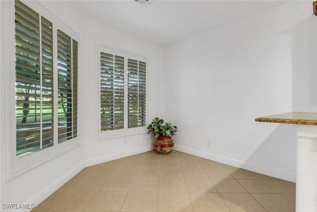 interior space featuring light tile patterned floors and baseboards