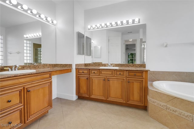 full bath featuring a sink, tile patterned floors, and two vanities