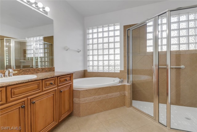 full bathroom featuring a bath, a shower stall, tile patterned flooring, and vanity