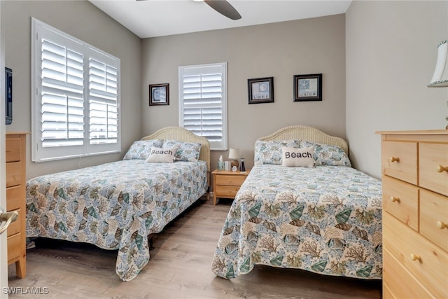 bedroom with ceiling fan and wood-type flooring