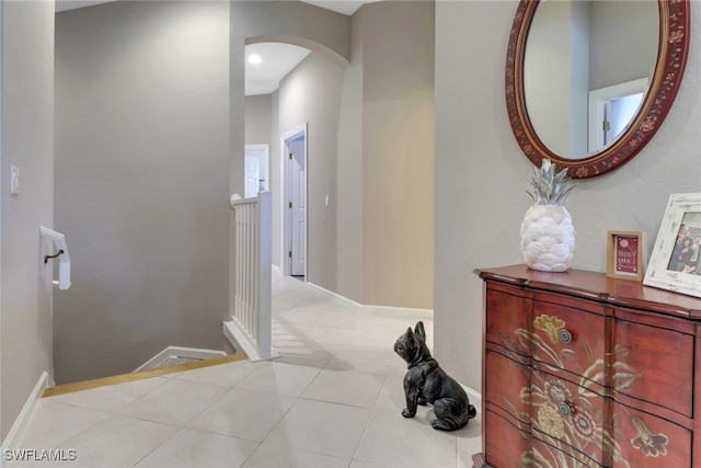 corridor with light tile patterned flooring