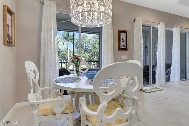 dining area with light tile patterned floors and an inviting chandelier