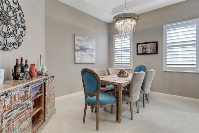 dining room with an inviting chandelier, plenty of natural light, ornamental molding, and light tile patterned flooring