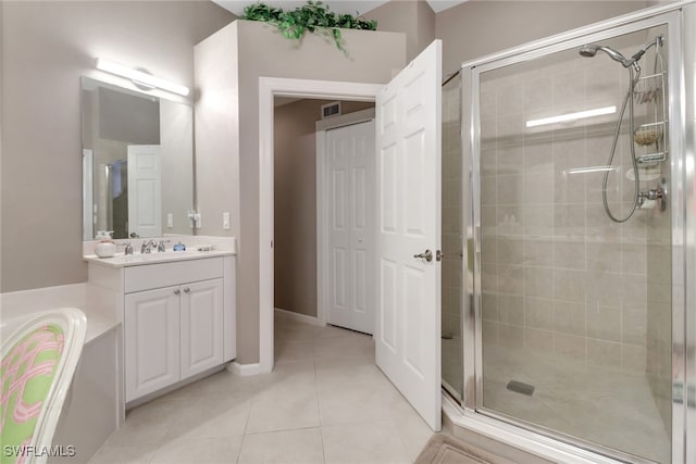 bathroom featuring tile patterned flooring, vanity, and a shower with shower door