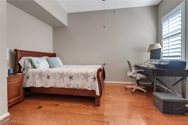 bedroom with hardwood / wood-style floors